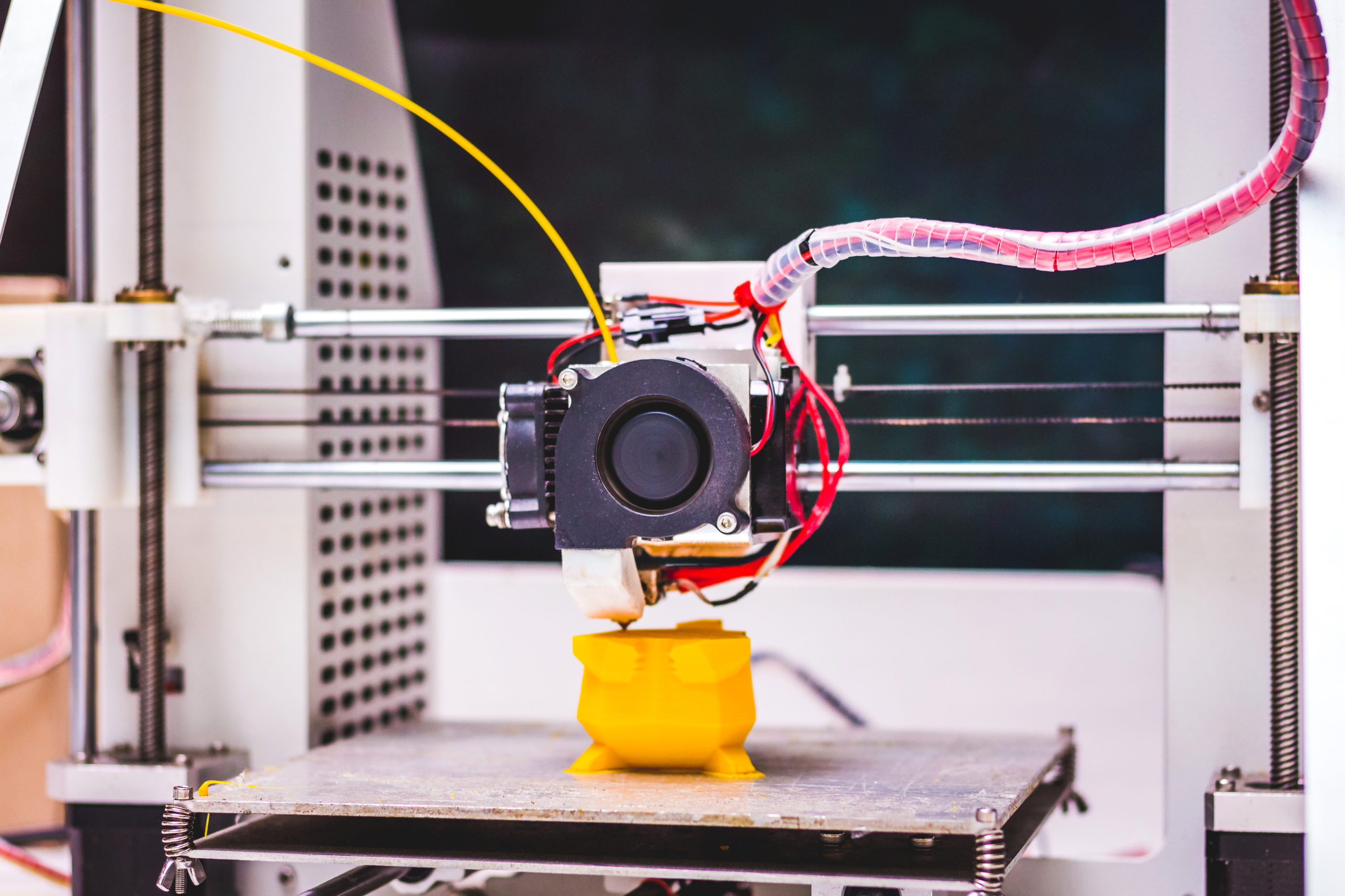 3d printer in work making plastic toy on d printer.jpg